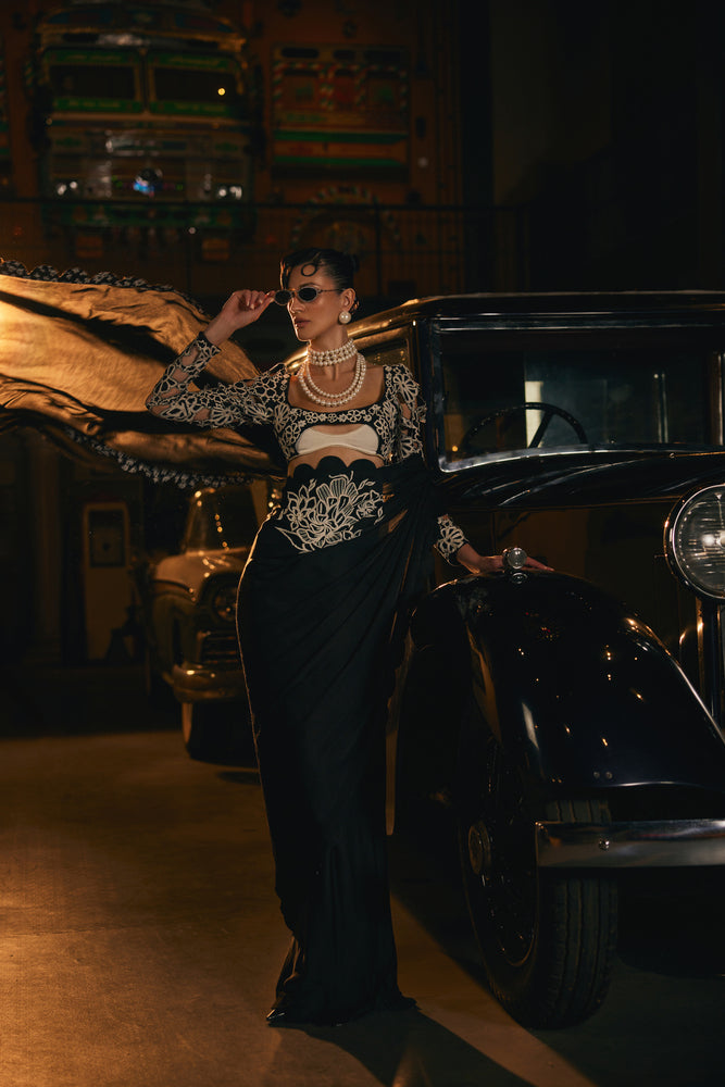 Black scalaped saree with black and white embroided blouse