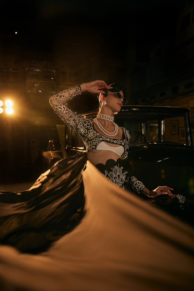 Black scalaped saree with black and white embroided blouse