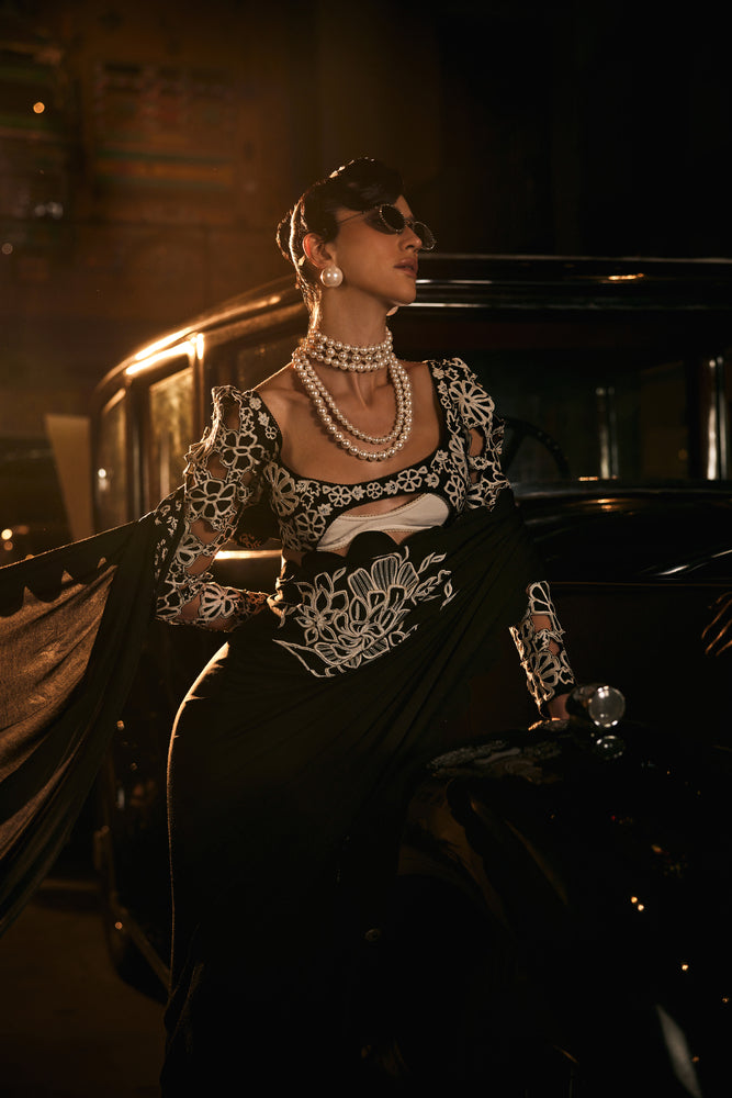 Black scalaped saree with black and white embroided blouse