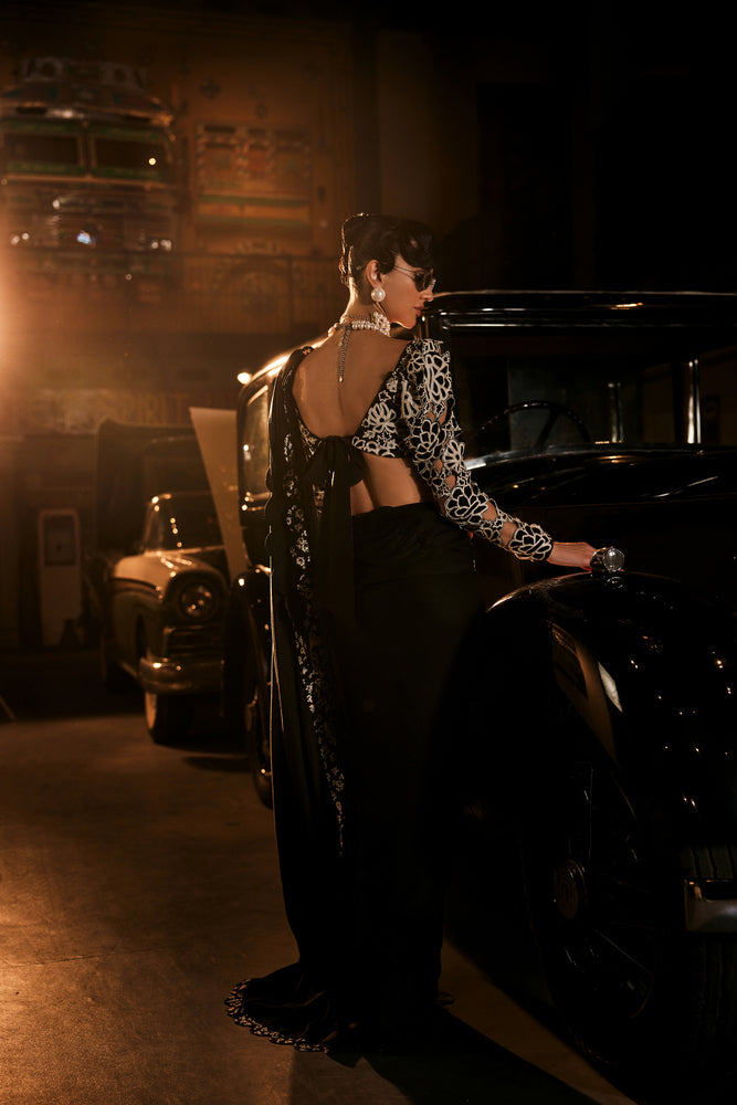 Black scalaped saree with black and white embroided blouse